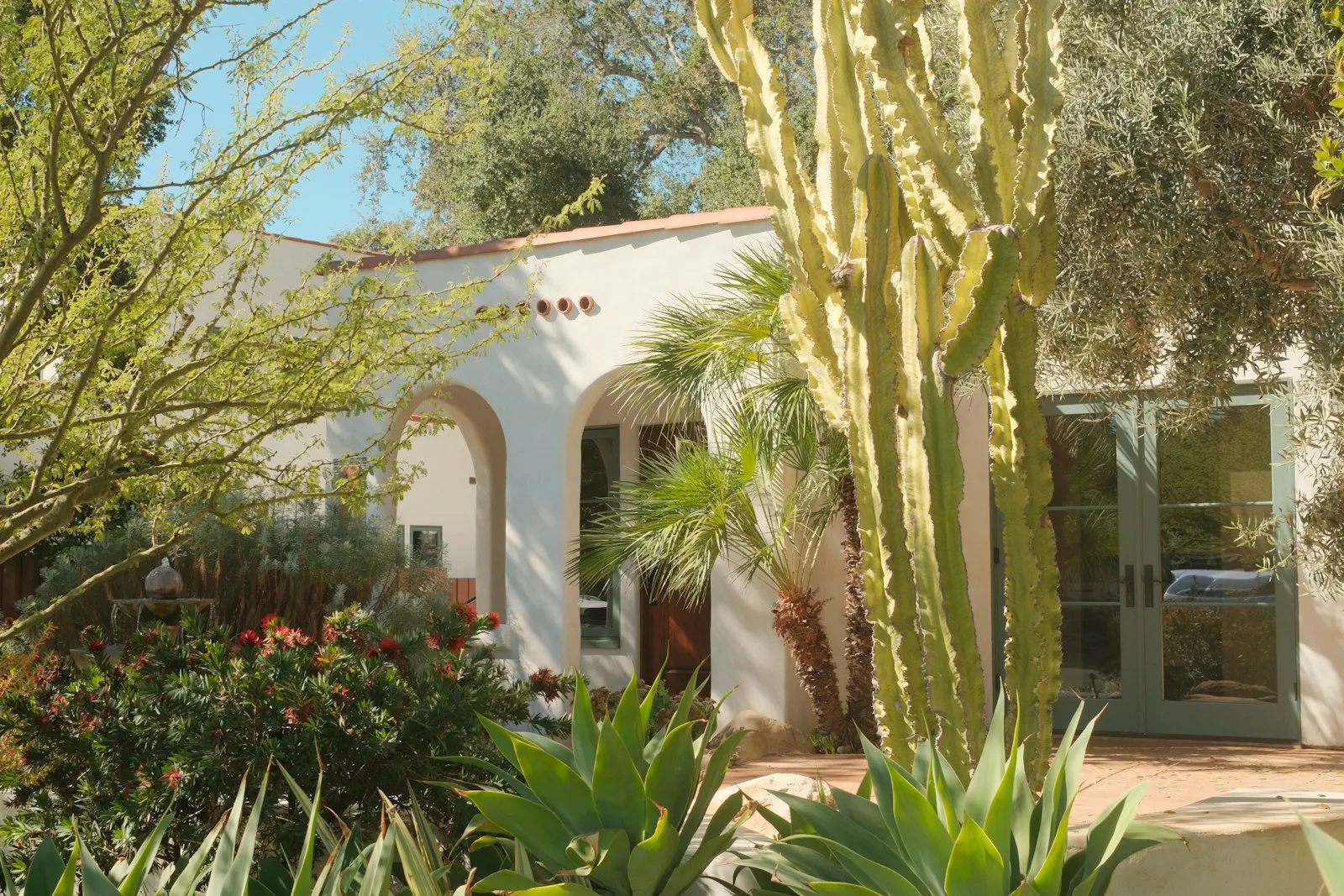 Spanish-style East Valley home with desert landscaping and shade trees.